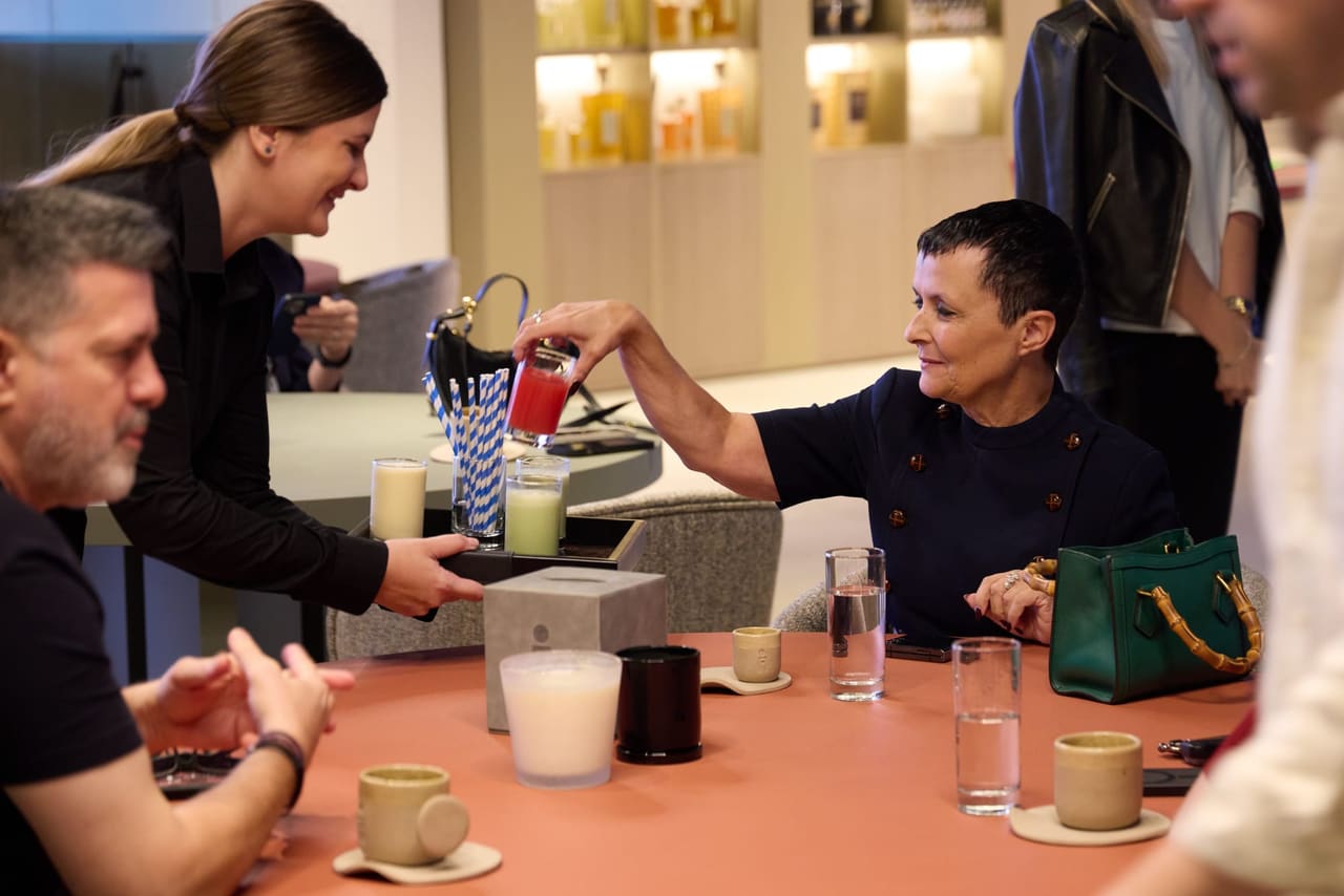 A server pouring a drink for guests at the Coffee Bar